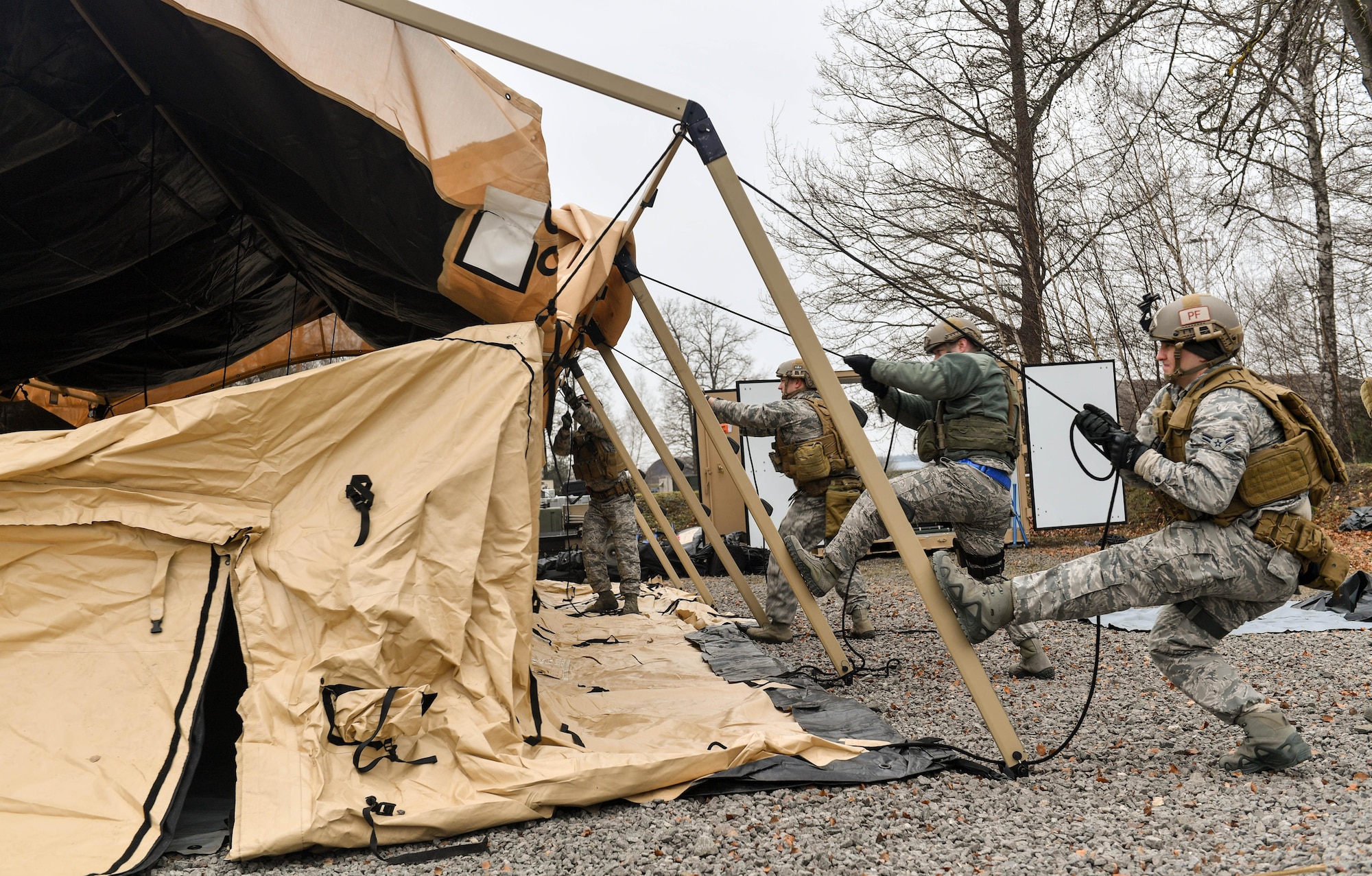 Airmen assigned to the 435th Contingency Response Group work together to build a tent during Exercise Austere Forge on Ramstein Air Base, Germany, Feb. 1, 2017. During the exercise, the Airmen planned what equipment would be used and who would be going, readied the equipment and personnel, processed through the 86th Logistic Readiness Squadron’s installation deployment readiness cell, and set up tents and equipment in a simulated deployed location. The 435 CRG participated in the exercise to practice their capability to deploy within 72 hours. (U.S. Air Force photo by Senior Airman Tryphena Mayhugh)