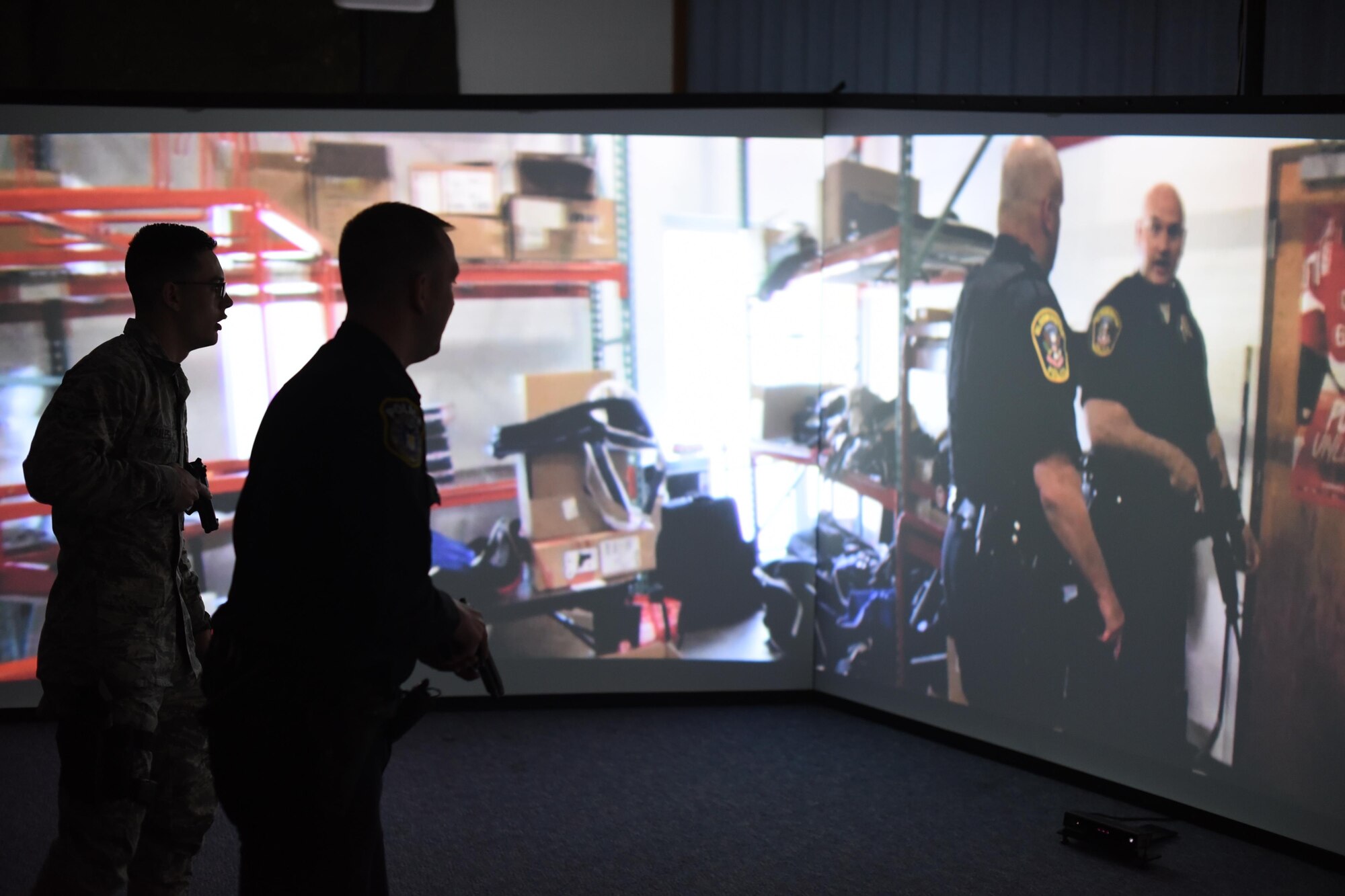 Airman 1st Class Alexander Morales, left, and Officer Ryan Lee, 22nd Security Forces Squadron patrolmen, use the Milo Range Training System, Feb. 1, 2017, at McConnell Air Force Base, Kan. The new training system has three interactive screens designed to improve situational awareness, tactics and weapon familiarization through various scenarios. (U.S. Air Force photo/Senior Airman Christopher Thornbury)