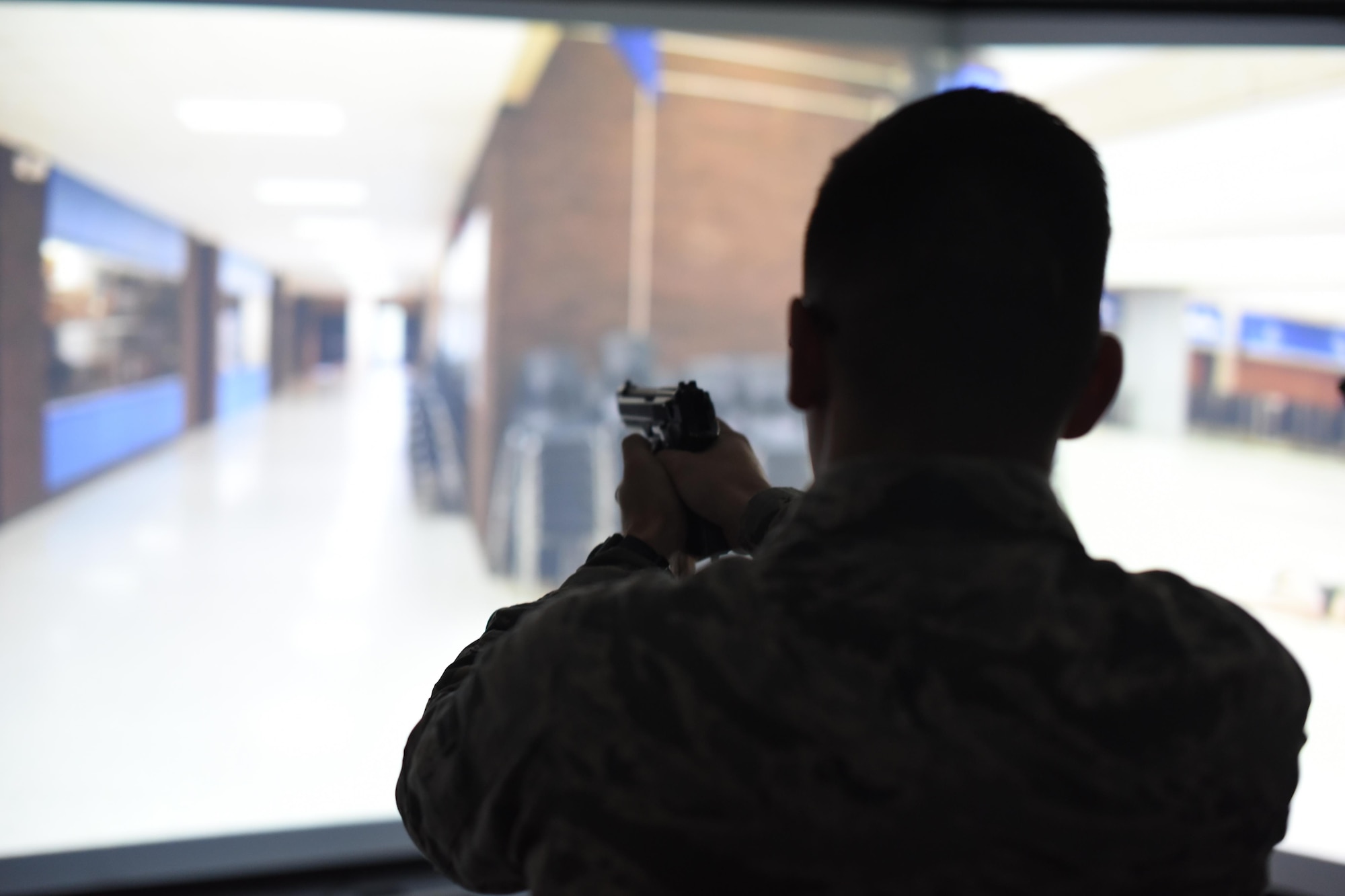 Airman 1st Class Alexander Morales, 22nd Security Forces Squadron patrolman, clears a hall during an active-shooter exercise with the Milo Range Training System, Feb. 1, 2017, at McConnell Air Force Base, Kan. It is the 22nd Security Forces Squadron’s responsibility to respond if or when a dire situation arises. To ensure the best result unfolds, they invested in their capabilities by bringing the new training system to the unit. (U.S. Air Force photo/Senior Airman Christopher Thornbury)