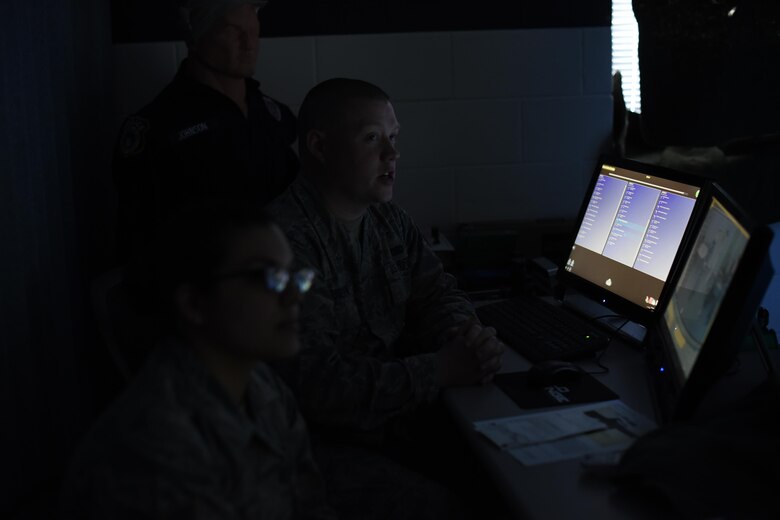 Staff Sgt. Tyler Cossentine, 22nd Security Forces Squadron NCO-in-charge of confinement, back and Staff Sgt. Kourtney Ruff, 22nd SFS NCOIC of training, evaluate the performance of other Defenders after using the Milo Range Training System, Feb. 1, 2017, at McConnell Air Force Base, Kan. Flight trainers will evaluate the users on their decisions to instill good habits and teach the reasoning behind the tactics. (U.S. Air Force photo/Senior Airman Christopher Thornbury)