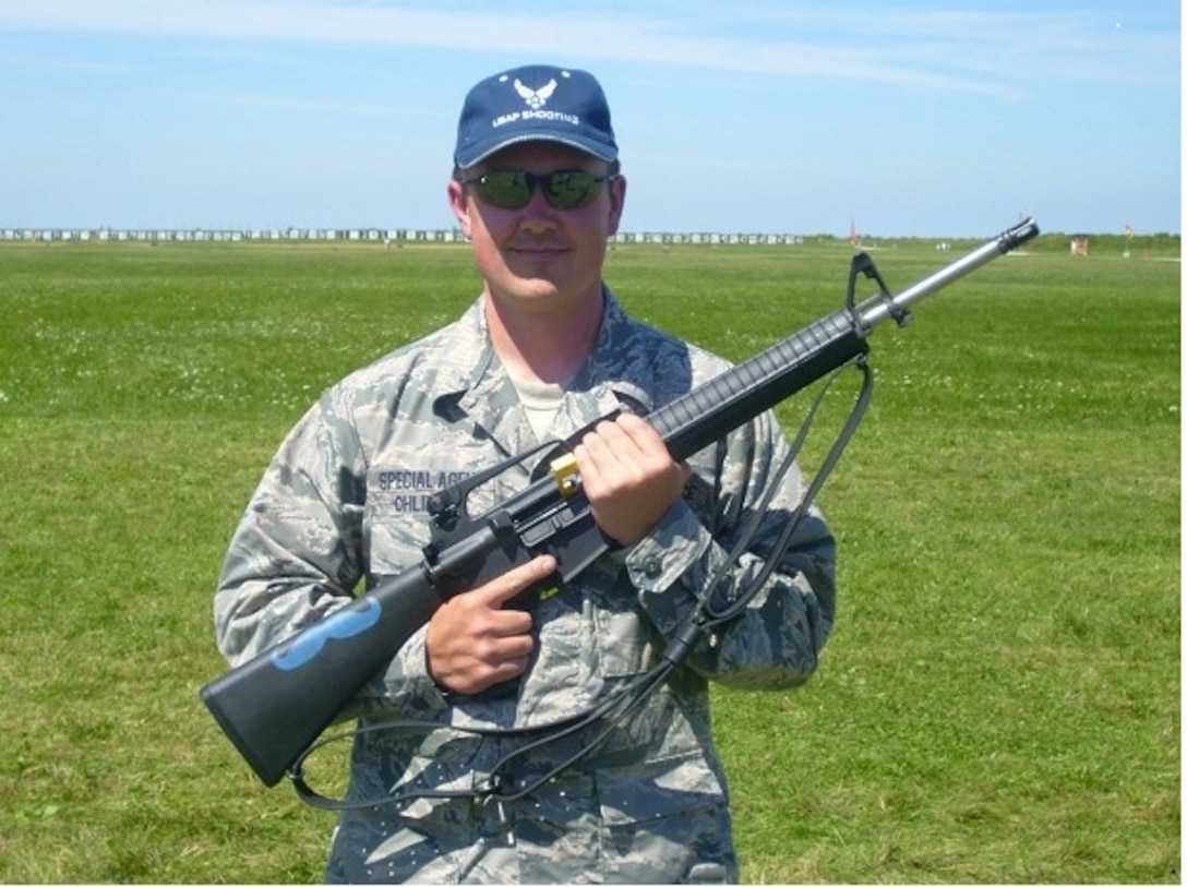 Air Force Office of Special Investigations Special Agent David Ohlinger holds the rifle used to earn him the Air Force Distinguished Rifleman Badge. SA Ohlinger is only the 353rd marksman in Air Force history to earn the coveted award. (U.S. Air Force photos/Staff Sgt. Andrew Lee) 