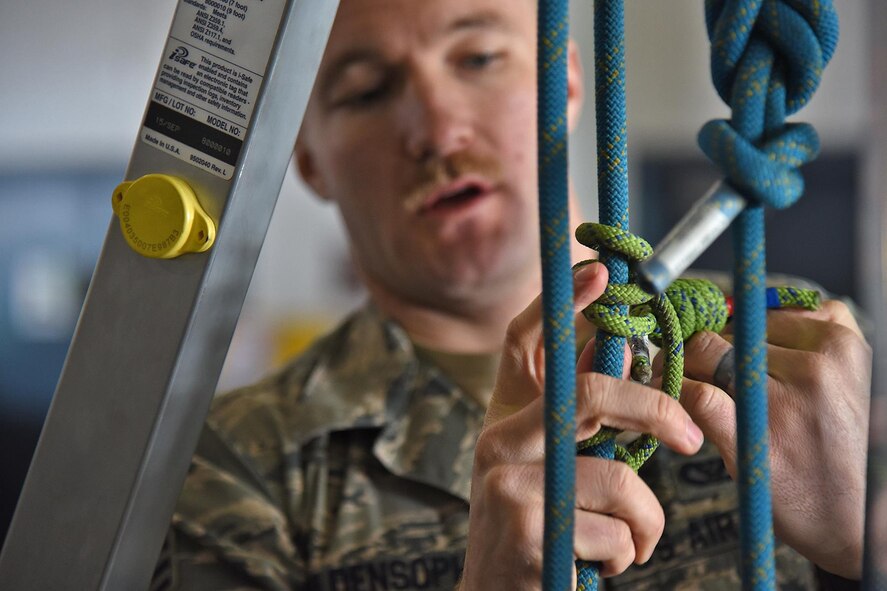 Senior Airman Curtis Goldensoph, 92nd Civil Engineer Squadron fire protection journeyman, assists in completing a lifting system during a confined spaces training Jan. 27, 2017, Fairchild Air Force Base, Wash. On average, Fairchild firefighters attend 15 to 20 classes per month to maintain skills, certifications and requirements gained throughout their careers. (U.S. Air Force photo/Senior Airman Mackenzie Richardson)