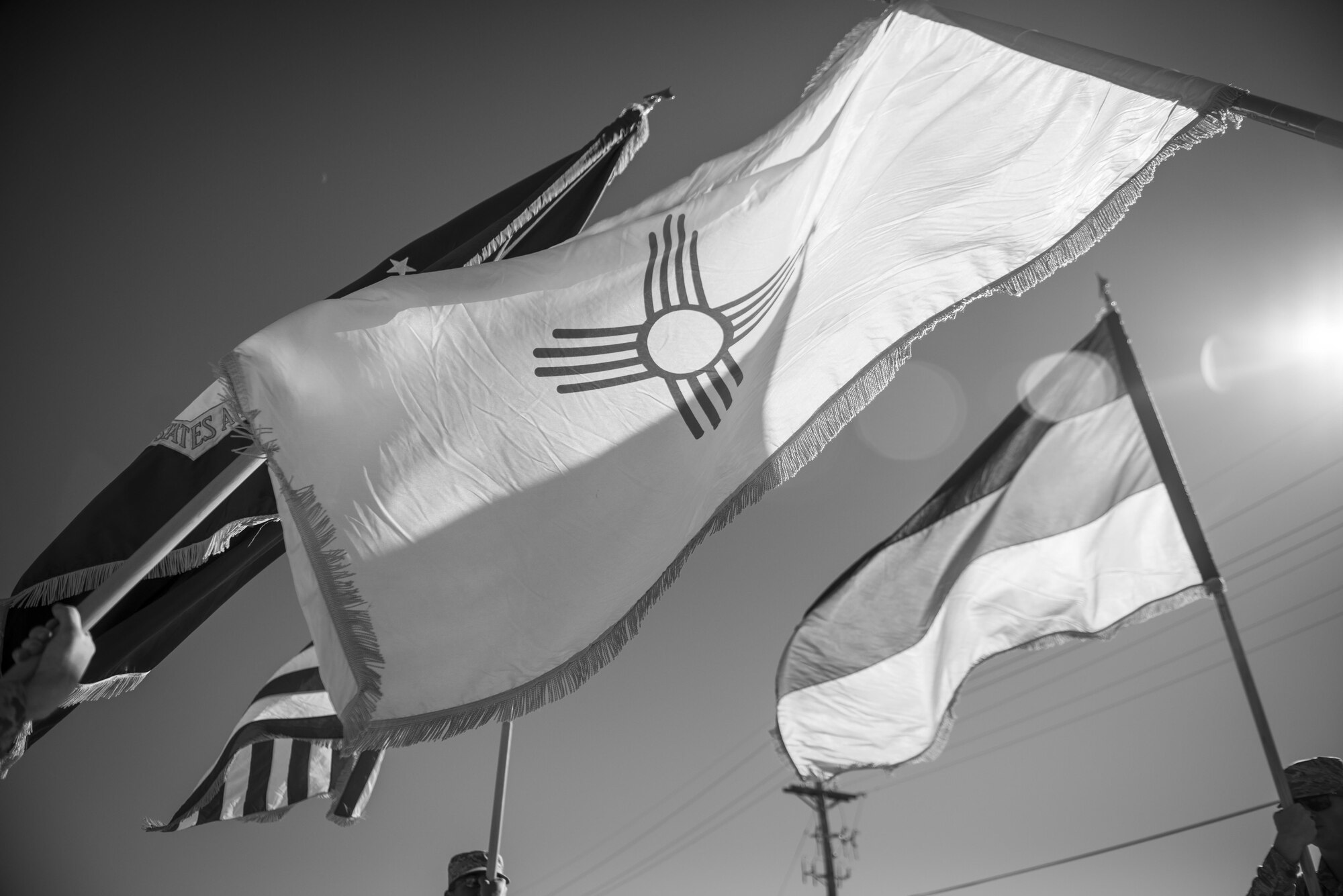 Flags are thrust into the air by Steel Talons Honor Guard members during a rendition of the colors ceremony at Heritage Park at Holloman Air Force Base, N.M., on Feb. 1, 2017. The Steel Talons Honor Guard was created to honor fallen members of the armed services, both past and present. The U.S. Air Force Honor Guard originated in 1948 and serves to represent Airmen to the American public and the world. (U.S. Air Force photo by Airman 1st Class Alexis P. Docherty) 