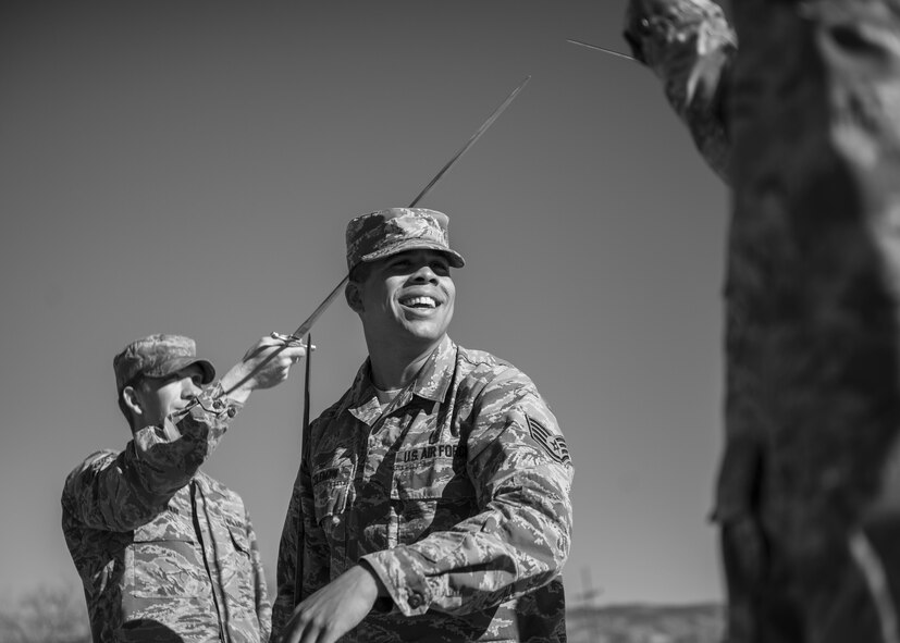 Staff Sgt. Maurice Coleman, the Steel Talons Honor Guard operations technician, instructs Steel Talons Honor Guard members on proper handling of a saber during a practice session at Heritage Park at Holloman Air Force Base, N.M., on Feb. 1, 2017. The Steel Talons Honor Guard was created to honor fallen members of the armed services, both past and present. To become a Steel Talons member, Airmen must complete their career development coursework, gain consent from their supervision and conform to the Air Force uniform and fitness standards. (U.S. Air Force photo by Airman 1st Class Alexis P. Docherty) 