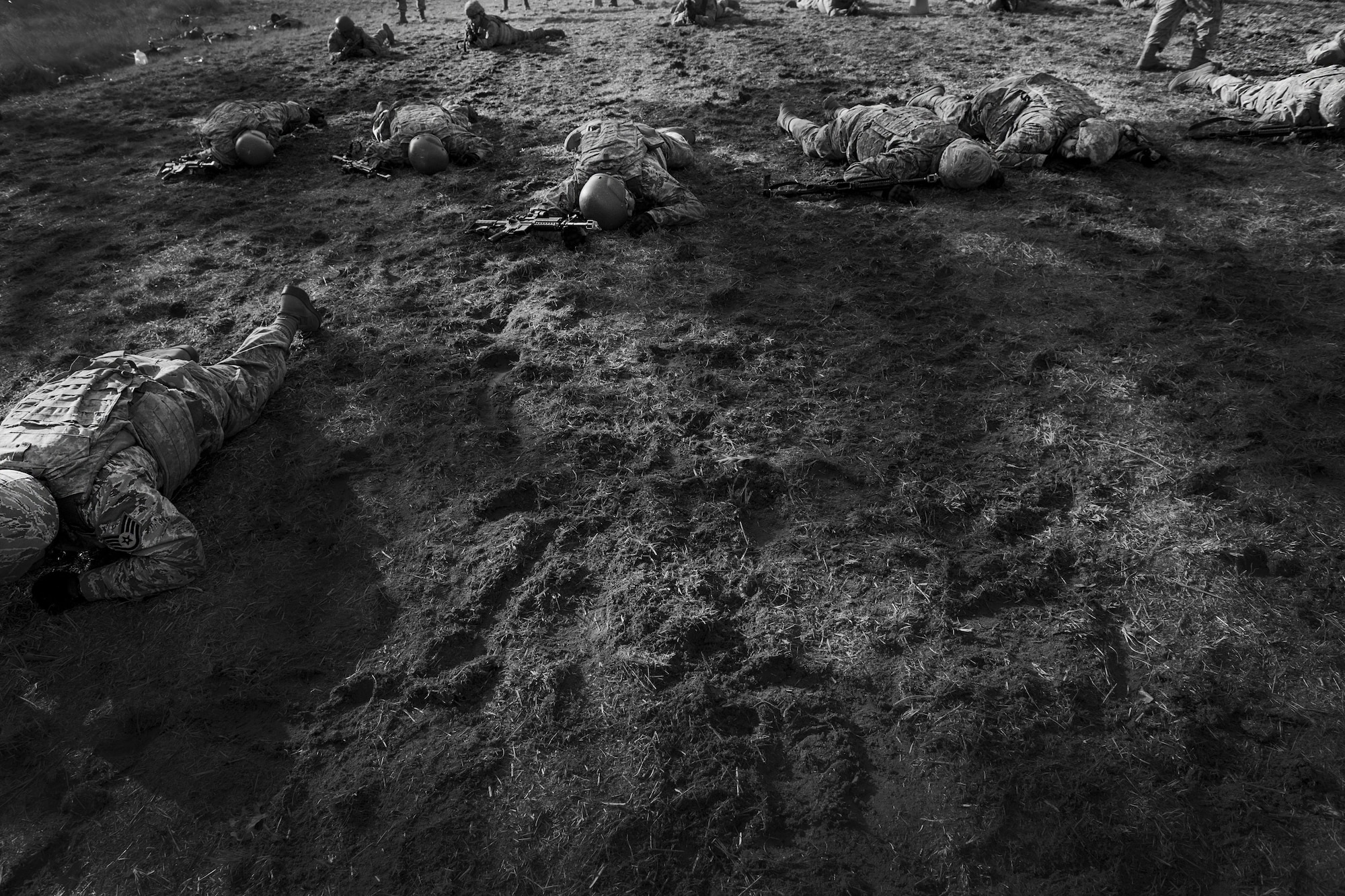 Field Craft Contingency Response students low crawl through a field during tactics training on Joint Base McGuire-Dix-Lakehurst, N.J. Feb. 2. The students used skills learned earlier in the day to move correctly as an individual and as a team.