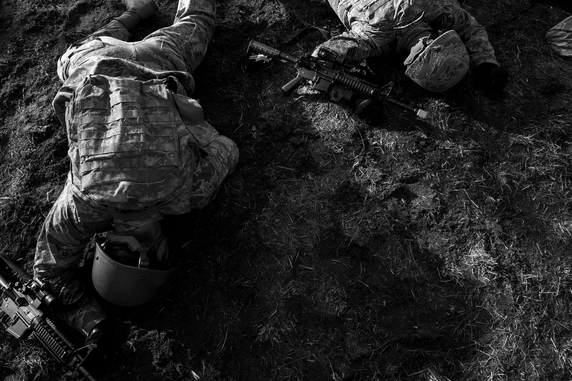 Field Craft Contingency Response students low crawl through field on Joint Base McGuire-Dix-Lakehurst, N.J. Feb. 2. FC CR graduates are category one qualified.