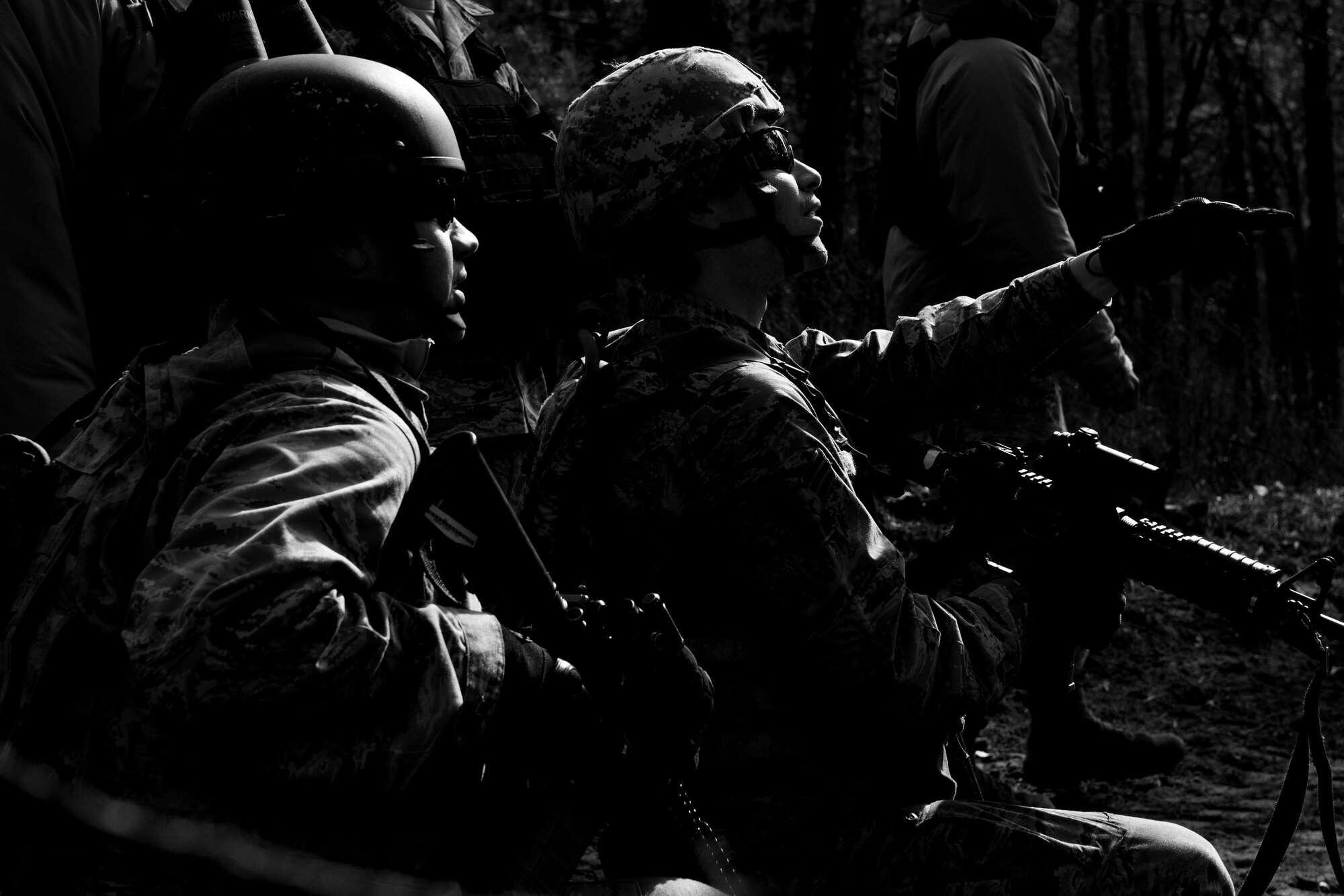Field Craft Contingency Response students look through the woods during tactics training on Joint Base McGuire-Dix-Lakehurst, N.J. Feb. 2. The students used skills learned earlier in the day to move correctly as an individual and as a team.