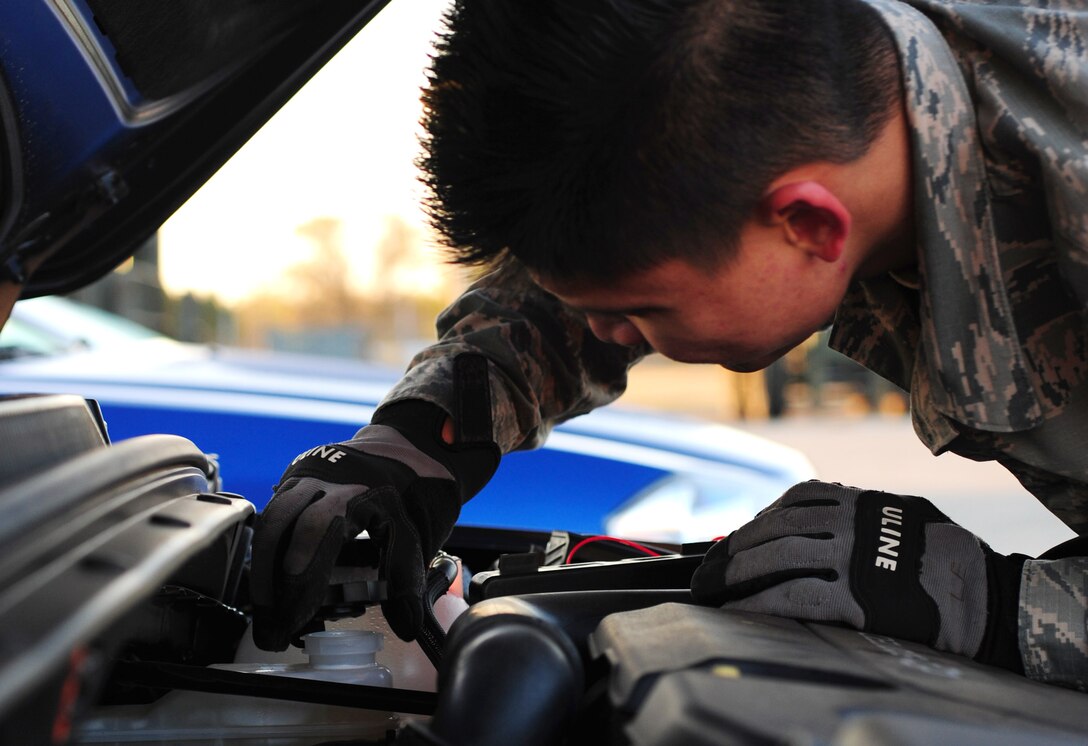 U.S. Air Force Airman 1st Class Tan Le, 7th Logistics Readiness Squadron vehicle operator, performs a vehicle check at Dyess Air Force Base, Texas, Dec. 12, 2016. Vehicle operators check the oil, tire pressure, windshield wipers and more on a weekly basis, and prior to every use, in order to make sure the vehicle is up-to-date on performance requirements. (U.S. Air Force photo by Airman 1st Class April Lancto)