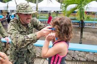 PUERTO BARRIOS, Guatemala (Feb. 3, 2017) -- Lt j.g. Jack Dembowski, a native of Alpharetta, Ga., attached to Destroyer Squadron (DESRON) 40, gives sunglasses to a host nation patient at the Continuing Promise 2017 (CP-17) medical site in Puerto Barrios, Guatemala. CP-17 is a U.S. Southern Command-sponsored and U.S. Naval Forces Southern Command/U.S. 4th Fleet-conducted deployment to conduct civil-military operations including humanitarian assistance, training engagements, and medical, dental, and veterinary support in an effort to show U.S. support and commitment to Central and South America. (U.S. Navy Photo by Mass Communication Specialist 2nd Class Shamira Purifoy)