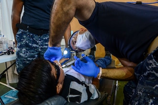 PUERTO BARRIOS, Guatemala (Feb. 3, 2017) -- Lt. Farid Hamidzadeh, a native of Fort Lauderdale, Fla., and a dentist assigned to Naval Hospital Jacksonville, Fla., administers a topical numbing agent to a host nation patient at the Continuing Promise 2017 (CP-17) medical site in Puerto Barrios, Guatemala. CP-17 is a U.S. Southern Command-sponsored and U.S. Naval Forces Southern Command/U.S. 4th Fleet-conducted deployment to conduct civil-military operations including humanitarian assistance, training engagements, and medical, dental, and veterinary support in an effort to show U.S. support and commitment to Central and South America. (U.S. Navy Combat Camera photo by Petty Officer 2nd Class Brittney Cannady)