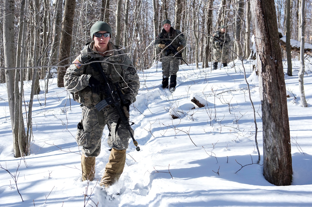 Army National Guardsmen advance to their objective rally point during winter training at Camp Ethan Allen Training Site in Jericho, Vt., Jan. 31, 2017. Air National Guard photo by Tech. Sgt. Sarah Mattison 