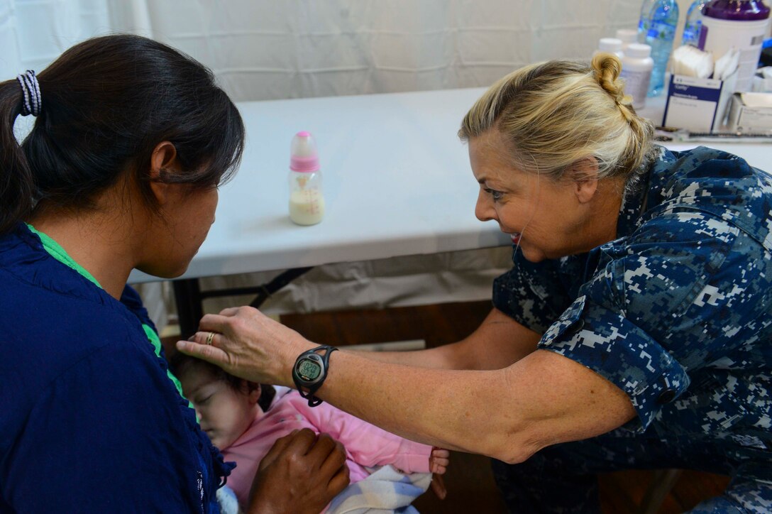 PUERTO BARRIOS, Guatemala (Feb. 3, 2017) -- Cmdr. Ellen Argo, a native of Stadford, Va., and nurse practitioner assigned to Naval Health Clinic Quantico, Va., examines a host nation patient during a wellness check at the Continuing Promise 2017 (CP-17) medical site in Puerto Barrios, Guatemala. CP-17 is a U.S. Southern Command-sponsored and U.S. Naval Forces Southern Command/U.S. 4th Fleet-conducted deployment to conduct civil-military operations including humanitarian assistance, training engagements, and medical, dental, and veterinary support in an effort to show U.S. support and commitment to Central and South America. (U.S. Navy Combat Camera photo by Petty Officer 2nd Class Brittney Cannady)