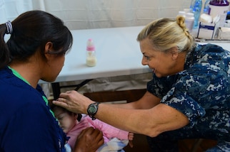 PUERTO BARRIOS, Guatemala (Feb. 3, 2017) -- Cmdr. Ellen Argo, a native of Stadford, Va., and nurse practitioner assigned to Naval Health Clinic Quantico, Va., examines a host nation patient during a wellness check at the Continuing Promise 2017 (CP-17) medical site in Puerto Barrios, Guatemala. CP-17 is a U.S. Southern Command-sponsored and U.S. Naval Forces Southern Command/U.S. 4th Fleet-conducted deployment to conduct civil-military operations including humanitarian assistance, training engagements, and medical, dental, and veterinary support in an effort to show U.S. support and commitment to Central and South America. (U.S. Navy Combat Camera photo by Petty Officer 2nd Class Brittney Cannady)