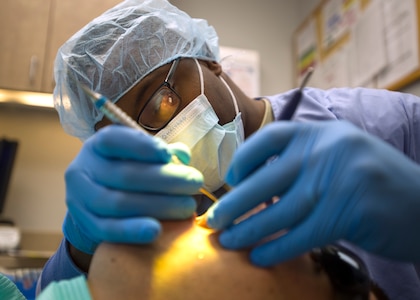 Staff Sgt. Tyre Jones, 359th Medical Group dental technician, cleans a patient’s teeth at the Randolph Dental Clinic on Joint Base San Antonio-Randolph, Texas, Jan. 10. Airmen are required to get a dental check-up annually to ensure good oral hygiene. (U.S. Air Force photo/Staff Sgt. Kevin Iinuma)