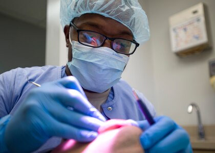 Staff Sgt. Tyre Jones, 359th Medical Group dental technician, a patient’s teeth at the Randolph Dental Clinic on Joint Base San Antonio-Randolph, Texas, Jan. 10. The Randolph Dental Clinic provides annual exams and cleanings for over 12,000 patients every year. (U.S. Air Force photo/Staff Sgt. Kevin Iinuma)