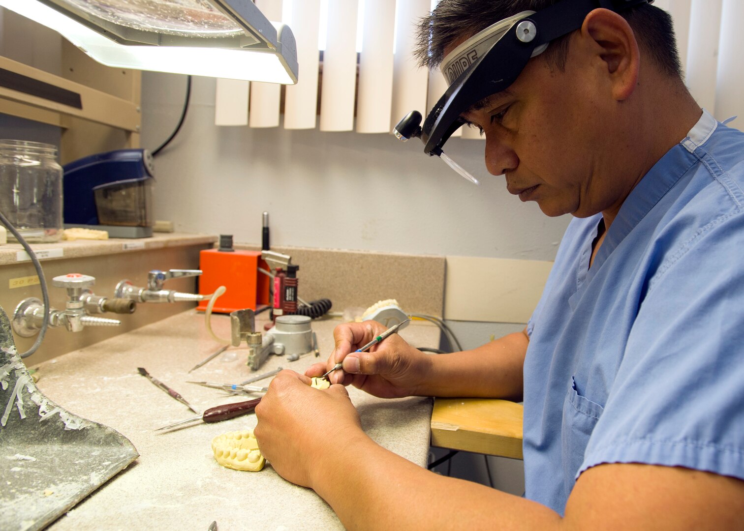 Jeffrey Paje, 359th Medical Group dental technician, carves through a patient’s dental mold to prepare an acrylic night guard at the Randolph Dental Clinic on Joint Base San Antonio-Randolph, Texas, Jan. 10. It takes approximately three to four hours to complete a patient’s night guard. (U.S. Air Force photo/Staff Sgt. Kevin Iinuma)