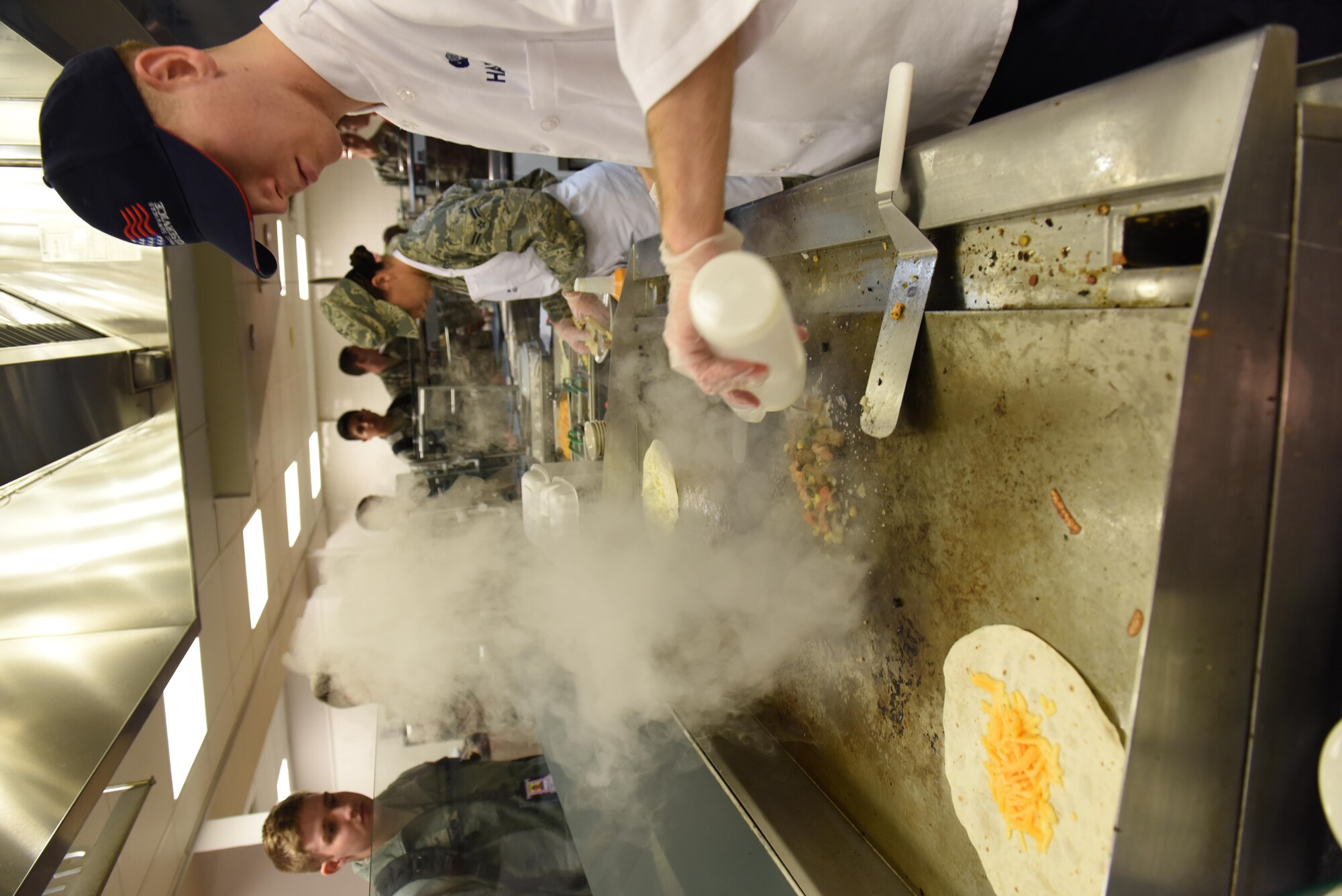 Airman 1st Class Kyle Harris, 2nd Force Support Squadron services Airman, prepares a quesadilla at the newly re-opened Red River Dining Facility at Barksdale Air Force Base, La., Feb. 2, 2017. The dining facility offers a large variety of food, giving airmen healthy and tasteful options for their meals. (U.S. Air Force photo/Senior Airman Luke Hill)