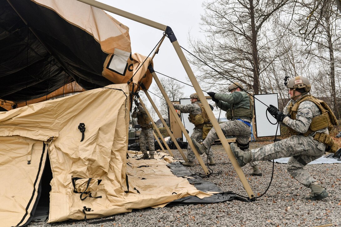 Airmen put up a tent during Exercise Austere Forge at Ramstein Air Base, Germany, Feb. 1, 2017. The airmen are assigned to the 435th Contingency Response Group. Air Force photo by Senior Airman Tryphena Mayhugh