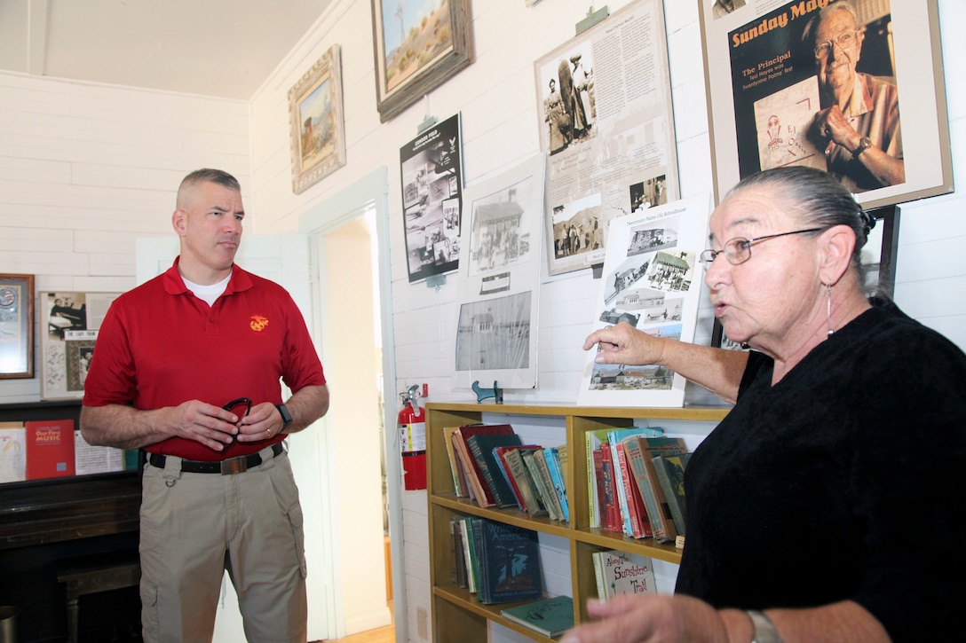 Brig. Gen. William F. Mullen III, Combat Center Commanding General, listens to Twentynine Palms Historical Society volunteer Pat Rimmington during a tour of the Old Schoolhouse Museum in Twentynine Palms, Calif., Jan. 31, 2017. The general and his wife toured the facility with Sgt. Maj. Michael J. Hendges, Combat Center Sergeant Major; Cpl. Ben Mills, driver; Jim Ricker, Combat Center Assistant Chief of Staff for Government and External Affairs; and Kristina Becker, Combat Center External Affairs Director. (Official Marine Corps photo by Kelly O'Sullivan/Released)