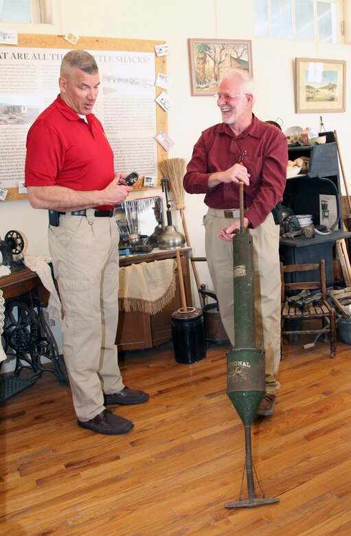 Twentynine Palms Historical Society President Les Snodgrass shows Brig. Gen. William F. Mullen III, Combat Center Commanding General, how early homesteaders vacuumed their homes during a tour of the Old Schoolhouse Museum in Twentynine Palms, Calif., Jan. 31, 2017. The general and his wife toured the facility with Sgt. Maj. Michael J. Hendges, Combat Center Sergeant Major; Cpl. Ben Mills, driver; Jim Ricker, Combat Center Assistant Chief of Staff for Government and External Affairs; and Kristina Becker, Combat Center External Affairs Director. (Official Marine Corps photo by Kelly O'Sullivan/Released)