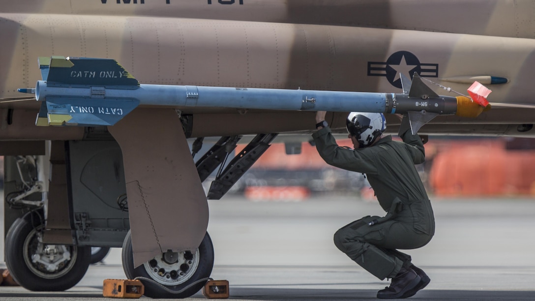 A pilot conducts a pre-flight check on the F-5N Tiger II aboard Marine Corps Air Station Beaufort, Jan. 26, 2017. Marine Fighter Training Squadron 401 worked with Marine Aviation Weapons and Tactics Squadron One to conduct the Marine Division Tactics Course at the air station. VMFT-401 provided the adversary air while the MAWTS-1 instructor pilots taught and evaluated MCAS Beaufort F/A-18 pilots during the course. The pilot is an instructor pilot with VMFT-401. Both VMFT-401 and MAWTS-1 are stationed aboard MCAS Yuma, Ariz.