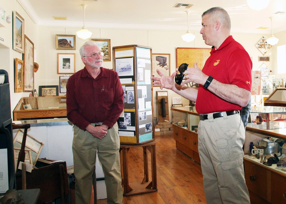 Brig. Gen. William F. Mullen III, Combat Center Commanding General, right, talks with Twentynine Palms Historical Society President Les Snodgrass, about local history during a tour of the Old Schoolhouse Museum in Twentynine Palms, Calif., Jan. 31, 2017. The general and his wife, Vicki, toured the facility with Sgt. Maj. Michael J. Hendges, Combat Center Sergeant Major; Cpl. Ben Mills, driver; Jim Ricker, Combat Center Assistant Chief of Staff for Government and External Affairs; and Kristina Becker, Combat Center External Affairs Director. (Official Marine Corps photo by Kelly O'Sullivan/Released)