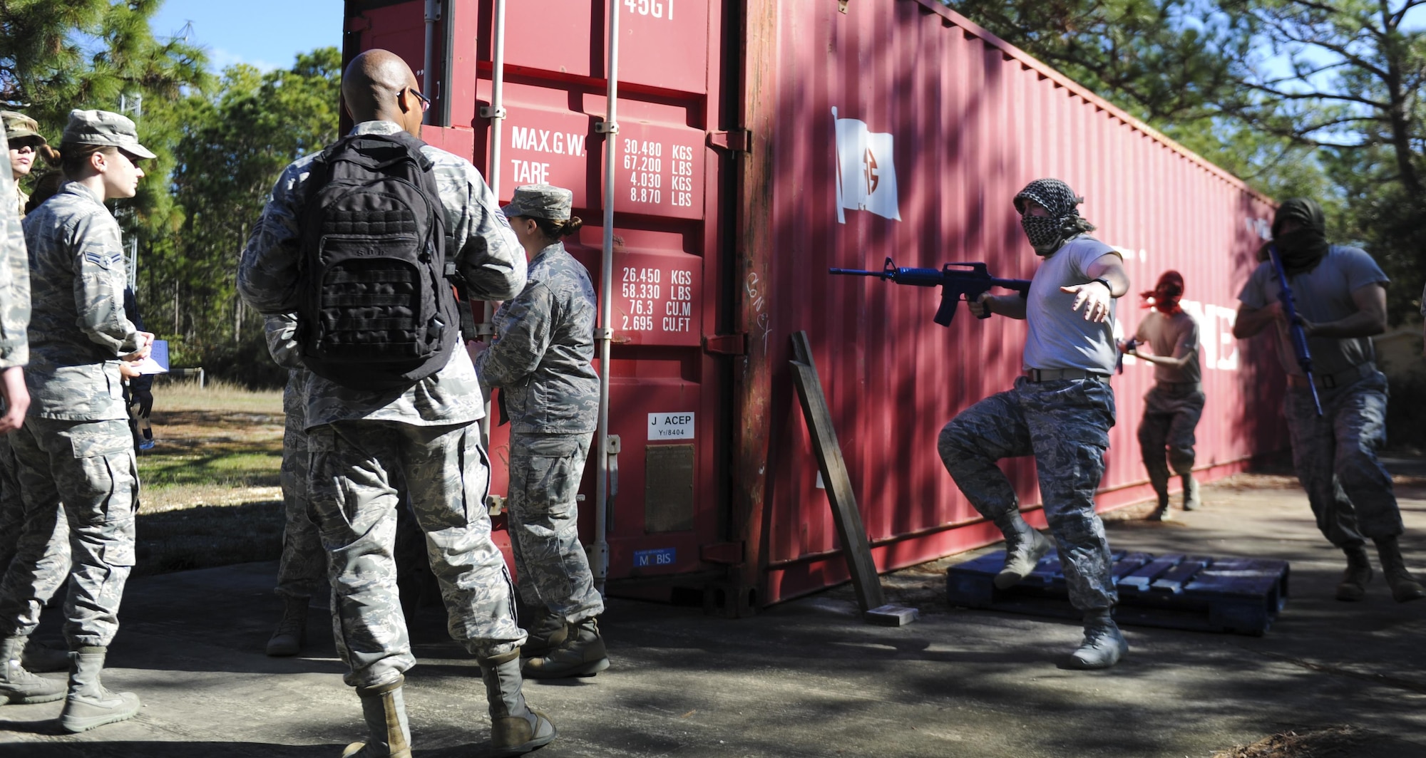 A simulated robbery takes place during the Joint Contingency Contracting Officer Training Exercise at Hurlburt Field, Fla., Feb. 2, 2017. Air Commandos, left, were performing a routine commodity purchase when a group of simulated opposition forces robbed them at gunpoint. (U.S. Air Force photo by Airman Dennis Spain)