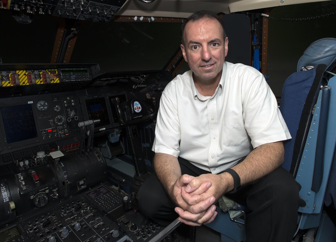 Retired Chief Master Sgt. Bryan Burns, 60th Operations Support Squadron, poses for a photo inside a C-5M Super Galaxy at Travis Air Force Base, Calif., June 6, 2016. Burns flew from McChord Air Force Base, Wash., to Travis AFB on July 9, 1986 in less than two hours to be present for the birth of his son Matthew. Burns served 25 years in the U.S. Air Force and retired in 2007. (U.S. Air Force Photo by Heide Couch/Released)