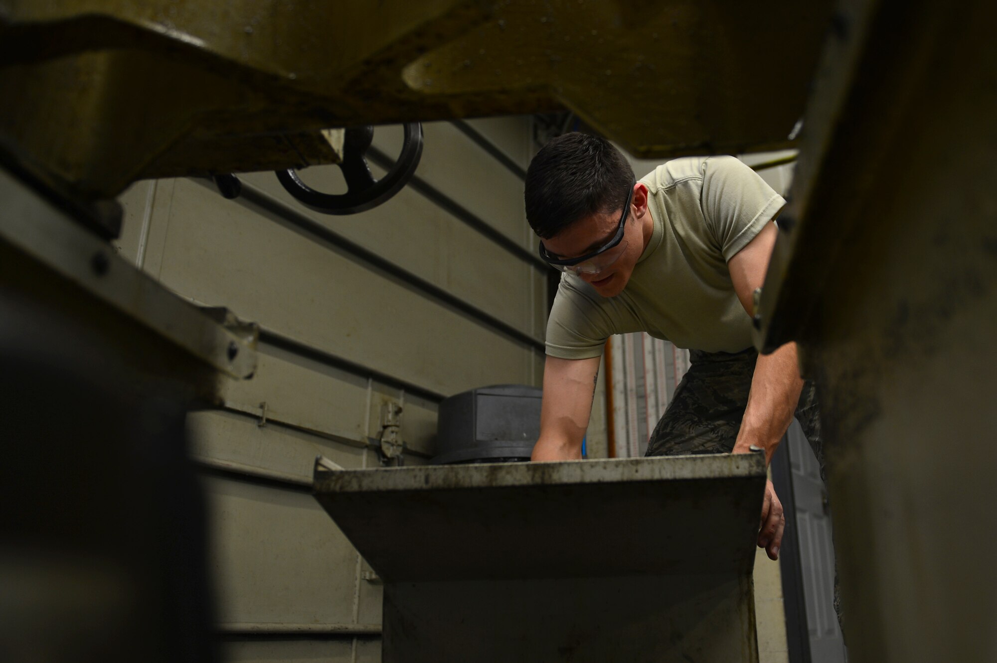 U.S. Air Force Airman 1st Class Mason Carny, 20th Equipment Maintenance Squadron aircraft metals technology technician, cleans coolant out of a piece of machinery at Shaw Air Force Base, S.C., Feb. 2, 2017. At the end of each shift, Airmen assigned to the 20th EMS metals technology lab are required to clean workspaces for Airmen entering the next shift. (U.S. Air Force photo by Airman 1st Class Christopher Maldonado)