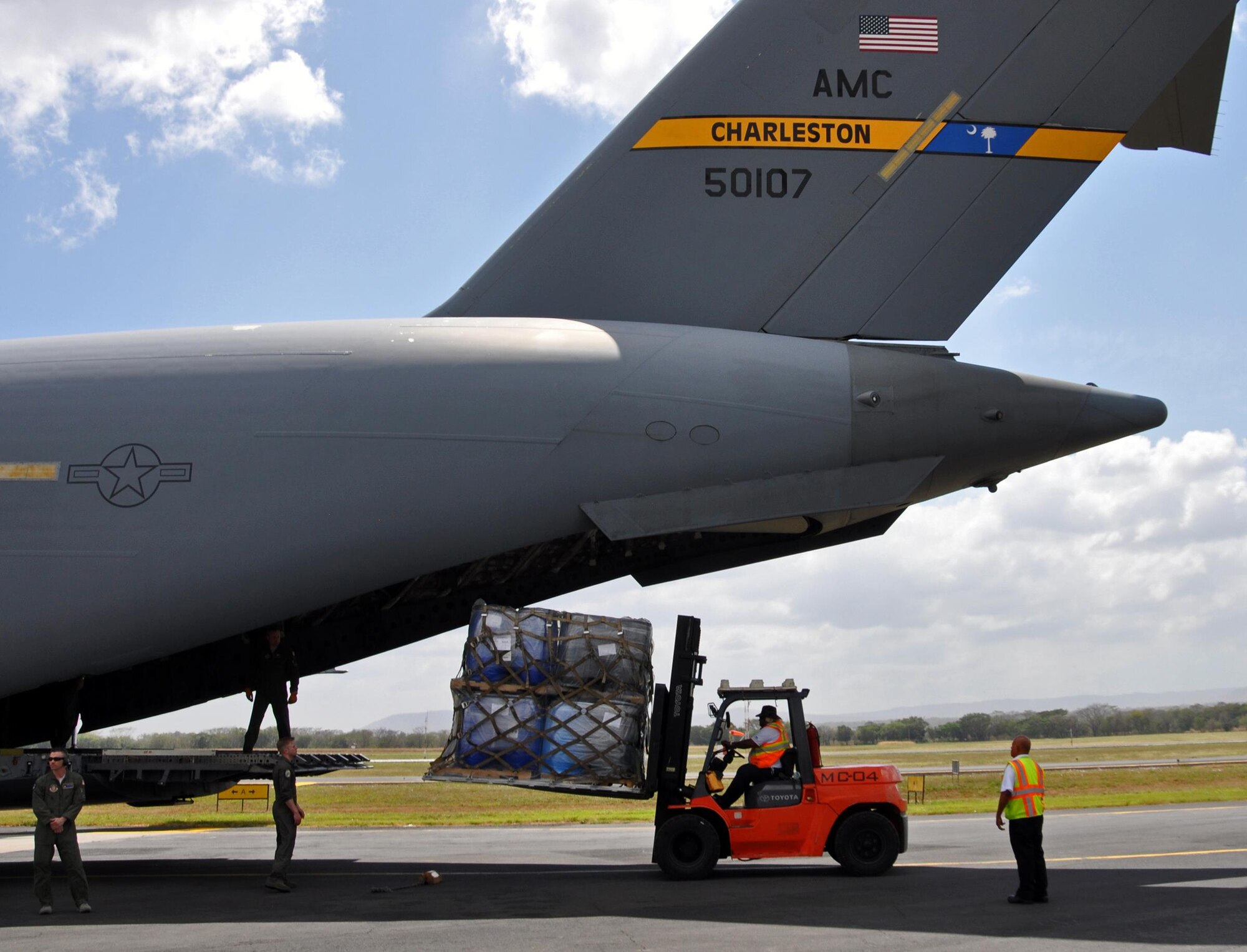 Palletized humanitarian aid cargo is offloaded from a Joint Base Charleston C-17 aircraft in Managua, Nicaragua, during a 315th Airlift Wing training mission, February 5, 2017.  The cargo, which was donated by groups within the U.S., was delivered as part of the Denton program, which allows for empty space on military cargo planes to be used for humanitarian relief.  (U.S. Air Force photo by Maj. Wayne Capps)