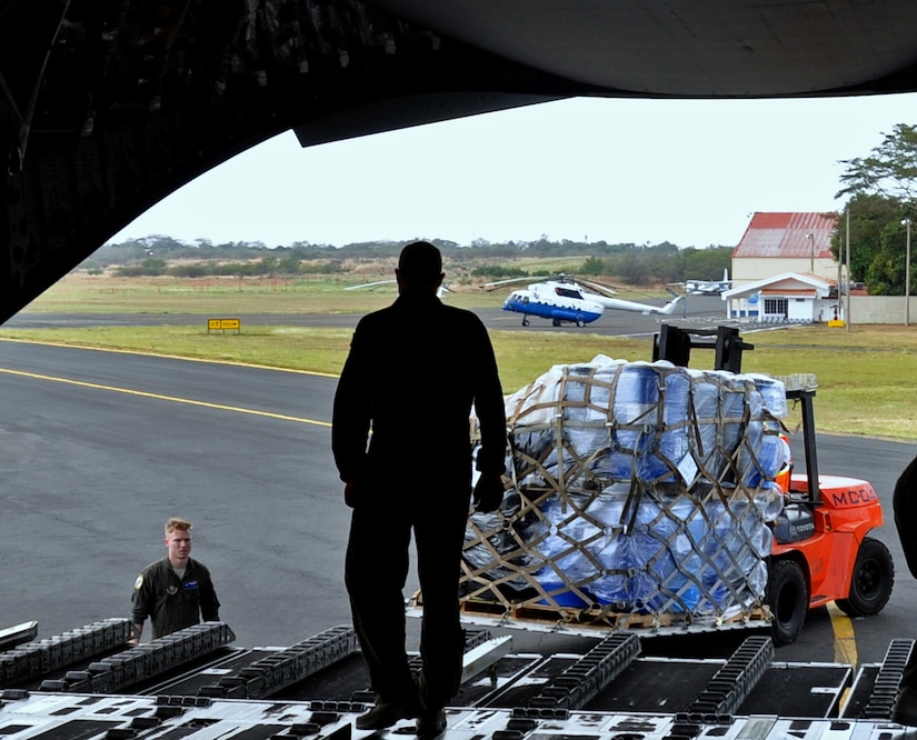 Master Sgt. Drew Cheek, loadmaster with the 300th Airlift Squadron, offloads humanitarian aid cargo from a C-17 aircraft in Managua, Nicaragua, Feb. 5, 2017.  The 315th Airlift Wing delivered the donated cargo to humanitarian organizations, which will provide an estimated 5.4 million meals to children in extreme poverty in Nicaragua and Haiti. (U.S. Air Force photo by 1st Lt. Justin Clark)
