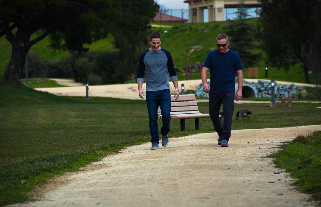 Staff Sgt. Hank Moon, 9th Air Refueling Squadron boom operator, and his brother Staff Sgt. Aaron Moon, 9th Air Refueling Squadron engine specialist, walk down a trail at Travis Air Force Base, California, on Jan. 31, 2017. The Moon brothers have been stationed together at Travis since 2011. (U.S. Air Force photo/Staff Sgt. Daniel Phelps)