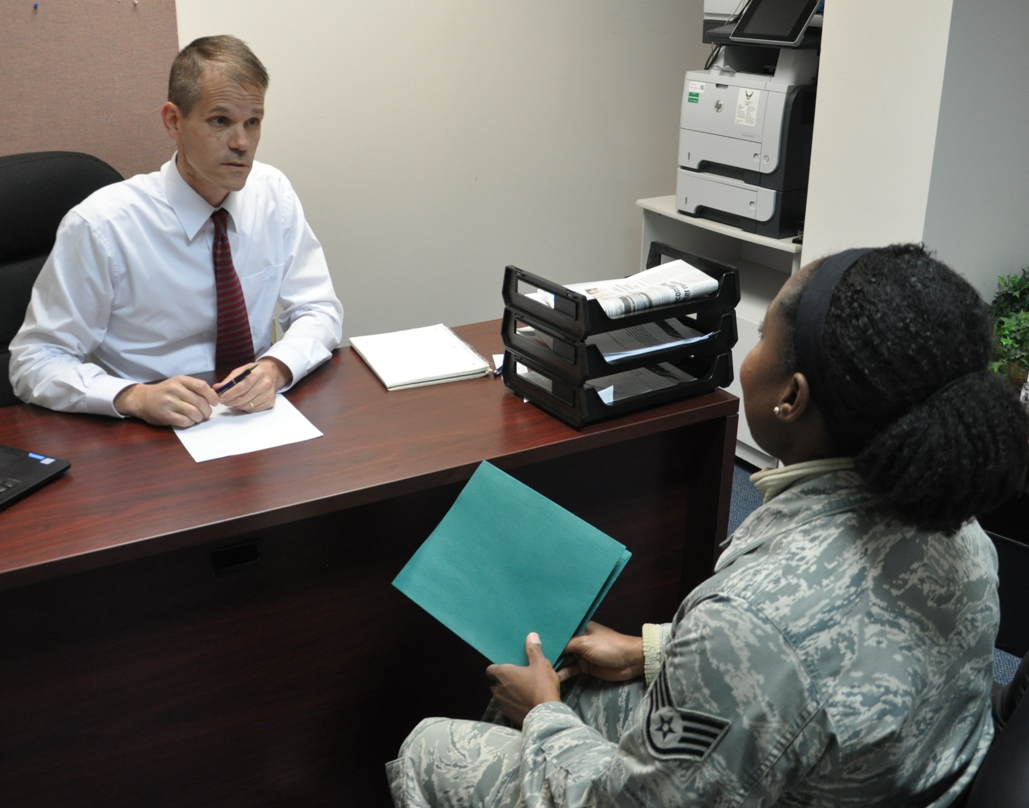 Staff Sgt. Jeria V. Dotson discusses finanancial planning with Micah Neuse, a personal financial counselor at the Airman and Family Readiness Center. (U.S. Air Force photo/W. Eugene Barnett Jr.)