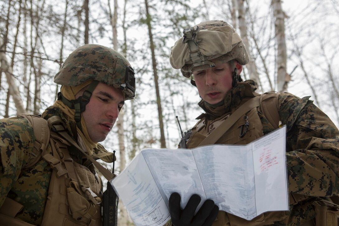 Cpl. Tevfik Ozkaynak (left), a rifleman with Company C, 1st Battalion, 25th Marine Regiment, 4th Marine Division and Sgt. Lee Gugino (right), a squad leader, observe objective points on a map while on a reconnaissance patrol during exercise Riley Xanten II, in Burwash, Ontario, Feb. 3-5, 2017. During the exercise, the Marines joined soldiers from the Canadian Armed Forces to exchange knowledge and increase proficiency in cold weather tactics, survival skills, shelter building, ice fishing, and more. (U.S. Marine Corps photo by Sgt. Sara Graham/released)