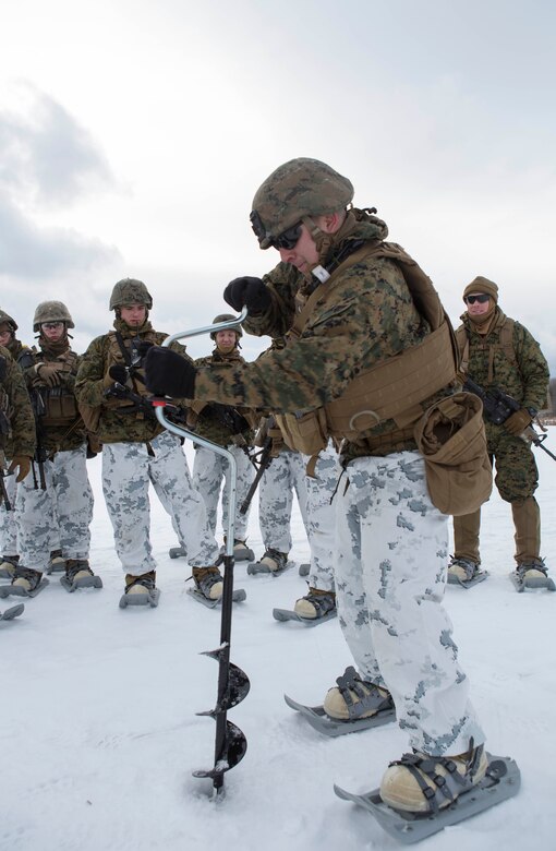 Sgt. Joe Lombardi, squad leader, Company C, 1st Battalion, 25th Marine Regiment, 4th Marine Division, drills a hole into ice to obtain food at exercise Riley Xanten II, in Burwash, Ontario, Feb. 3-5, 2017. During the exercise, the Marines joined soldiers from the Canadian Armed Forces to exchange knowledge and increase proficiency in cold weather tactics, survival skills, shelter building, ice fishing, and more. (U.S. Marine Corps photo by Sgt. Sara Graham/released)