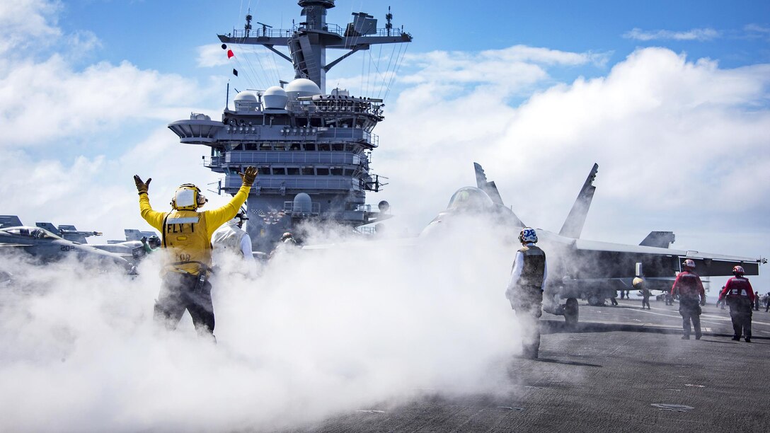 A sailor uses hand signals while conducting flight operations on the flight deck aboard the aircraft carrier USS Carl Vinson in the Pacific Ocean, Jan. 30, 2017. Navy photo by Petty Officer 2nd Class Sean M. Castellano