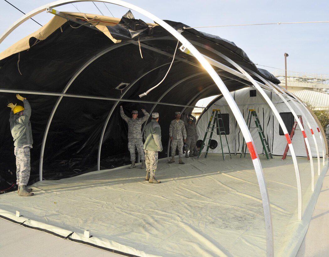 Airmen from the 919 Special Operations Force Support Squadron begin building a tent structure during the unit training assembly Feb. 5 at Duke Field, Fla.  The Airmen built the tent then served a meal out of it to meet an annual training requirement.  (U.S. Air Force photo/Dan Neely) 