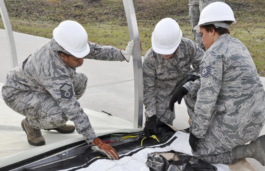 Airmen from the 919 Special Operations Force Support Squadron begin building a tent structure during the unit training assembly Feb. 5 at Duke Field, Fla.  The Airmen built the tent then served a meal out of it to meet an annual training requirement.  (U.S. Air Force photo/Dan Neely) 