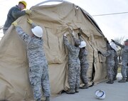 Airmen from the 919 Special Operations Force Support Squadron begin building a tent structure during the unit training assembly Feb. 5 at Duke Field, Fla.  The Airmen built the tent then served a meal out of it to meet an annual training requirement.  (U.S. Air Force photo/Dan Neely) 