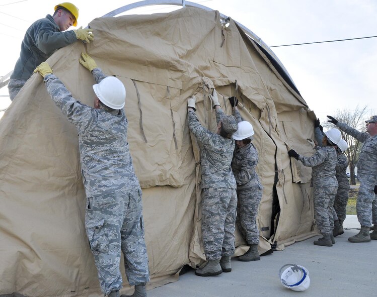 Airmen from the 919 Special Operations Force Support Squadron begin building a tent structure during the unit training assembly Feb. 5 at Duke Field, Fla.  The Airmen built the tent then served a meal out of it to meet an annual training requirement.  (U.S. Air Force photo/Dan Neely) 