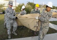 Airmen from the 919 Special Operations Force Support Squadron begin building a tent structure during the unit training assembly Feb. 5 at Duke Field, Fla.  The Airmen built the tent then served a meal out of it to meet an annual training requirement.  (U.S. Air Force photo/Dan Neely) 