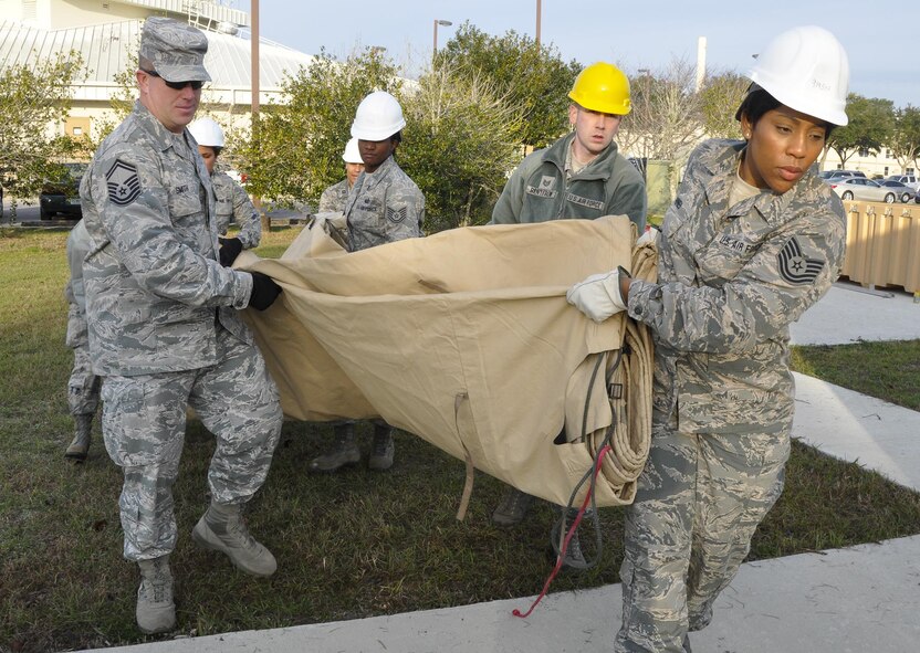 Airmen from the 919 Special Operations Force Support Squadron begin building a tent structure during the unit training assembly Feb. 5 at Duke Field, Fla.  The Airmen built the tent then served a meal out of it to meet an annual training requirement.  (U.S. Air Force photo/Dan Neely) 