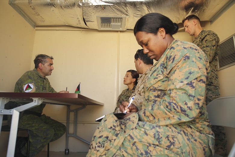 Marines with Task Force Southwest speak with an interpreter and Afghani role player during a rapport-building exercise at Camp Lejeune, N.C., Feb. 2, 2016. A team of about 30 Marines assigned to the unit trained to enhance their communication skills and to better understand Afghani culture in preparation for an upcoming deployment to Helmand Province, Afghanistan. Approximately 300 Marines with Task Force Southwest will train, advise and assist the Afghan National Army 215th Corps and 505th Zone National Police. (U.S. Marine Corps photo by Sgt. Lucas Hopkins)