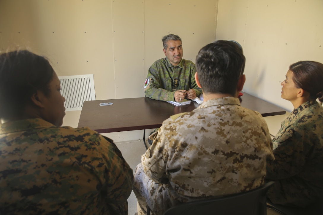 Marines with Task Force Southwest (left, right) speak with an Afghani role player and an interpreter during a rapport-building exercise at Camp Lejeune, N.C., Feb. 2, 2016. Approximately 300 Marines with the unit are preparing for an upcoming deployment to Helmand Province, Afghanistan, where they will train, advise and assist the Afghan National Army 215th Corps and 505th Zone National Police. (U.S. Marine Corps photo by Sgt. Lucas Hopkins)