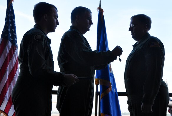 Col. James Phillips, 919th Special Operations Wing commander, presents a medal to Lt. Col. Tom Miller during his retirement ceremony Feb. 4 at Duke Field, Fla.  (U.S. Air Force photo/Dan Neely)