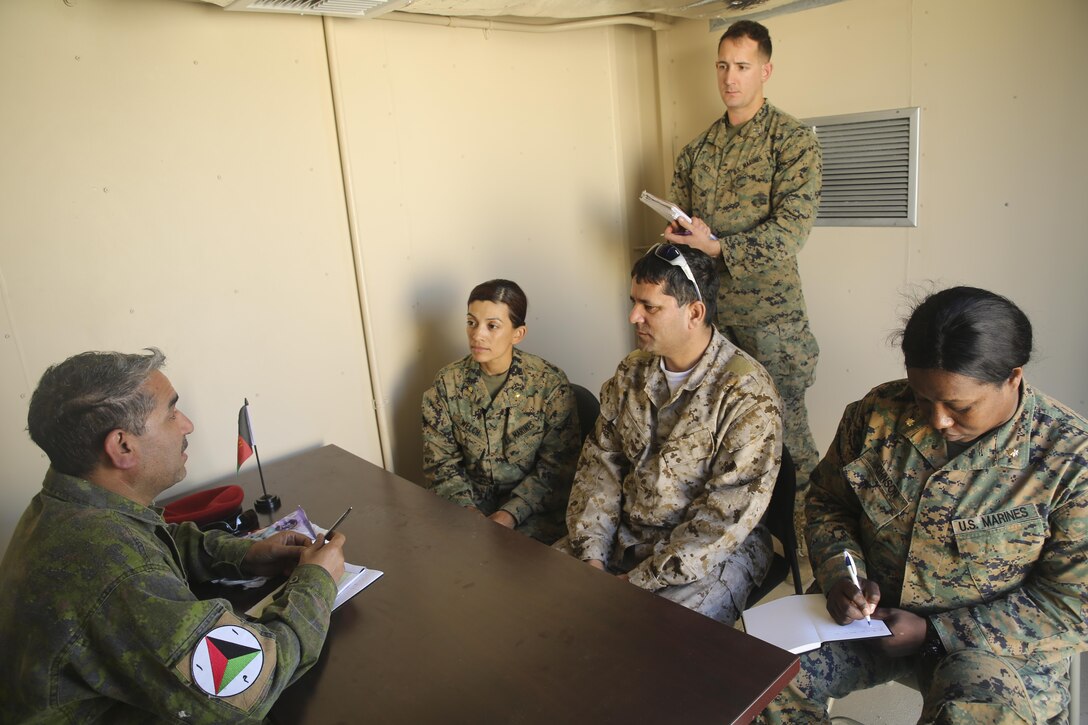 Marines with Task Force Southwest speak with an Afghan role player and an interpreter during a rapport-building exercise at Camp Lejeune, N.C., Feb. 2, 2016. A team of about 30 Marines with the unit trained to enhance their communicative skillsets and build relationships with role players in preparation for an upcoming deployment to Helmand Province, Afghanistan. Task Force Southwest is comprised of approximately 300 Marines, whose mission will be to train, advise and assist the Afghan National Army 215th Corps and 505th Zone National Police. (U.S. Marine Corps photo by Sgt. Lucas Hopkins)