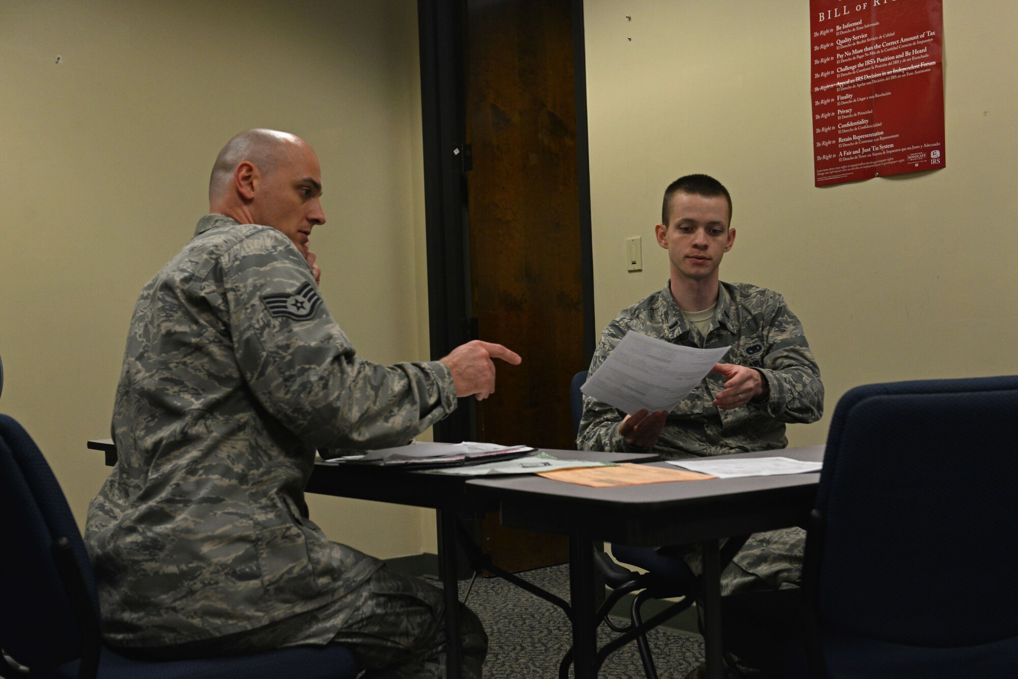 U.S. Air Force Staff Sgt. Gustab Monaco, 20th Equipment Maintenance Squadron aircraft structural maintenance craftsman, discusses tax forms with 1st Lt. Matthew Zollmann, 20th Logistics Readiness Squadron fuels management flight commander and tax center volunteer, at Shaw Air Force Base, S.C., Feb. 6, 2017. Accepting both reservations and walk-ins, tax center volunteers are available until April 18 to walk service members and retirees through filing their taxes. (U.S. Air Force photo by Airman 1st Class Destinee Sweeney)