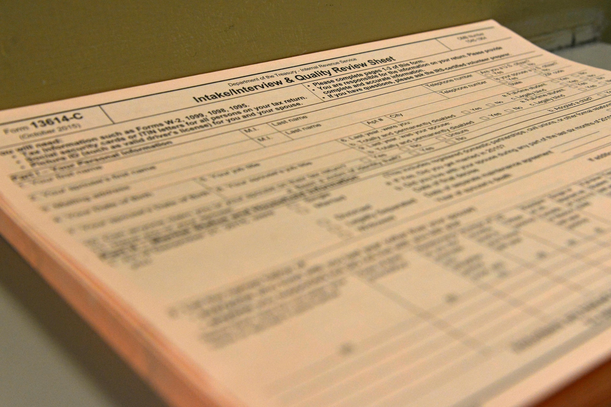 An intake/interview and quality review sheet lays on the front desk of the tax center at Shaw Air Force Base, S.C., Feb. 6, 2017. The form requires identification information such as name and date of birth as well as information from the past year on the income, expenses and life events of the individual filing taxes. (U.S. Air Force photo by Airman 1st Class Destinee Sweeney)