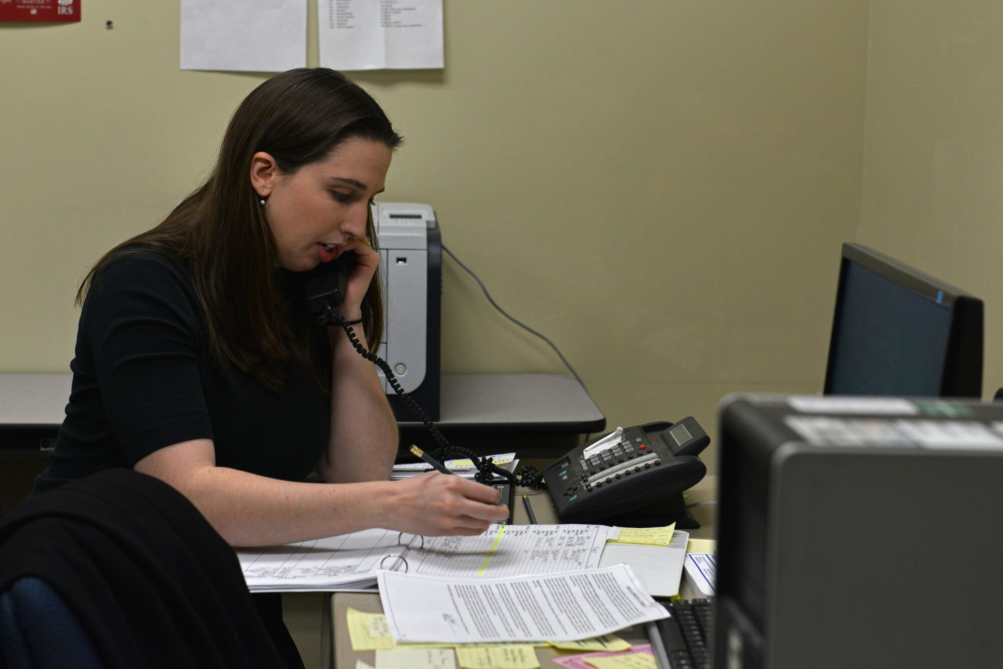 Marie Davis, tax center volunteer, schedules an appointment over the phone at Shaw Air Force Base, S.C., Feb. 6, 2017. The tax center offers appointments Monday through Thursday and accepts walk-ins with a 1040 EZ form on Fridays. (U.S. Air Force photo by Airman 1st Class Destinee Sweeney)