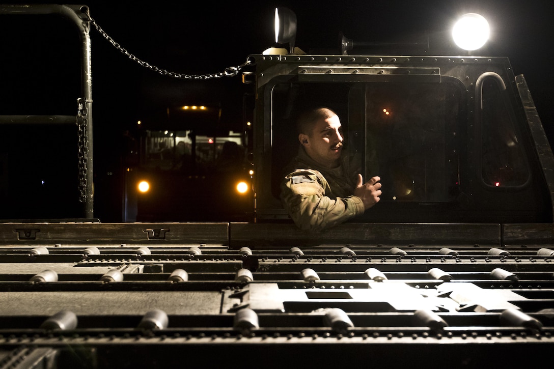 U.S. Air Force Staff Sgt. Darren Arsenault, with the 387th Air Expeditionary Group, helps to load cargo on to a C-130 Hercules at Ali Al Salem, Kuwait, on February 2, 2017. 